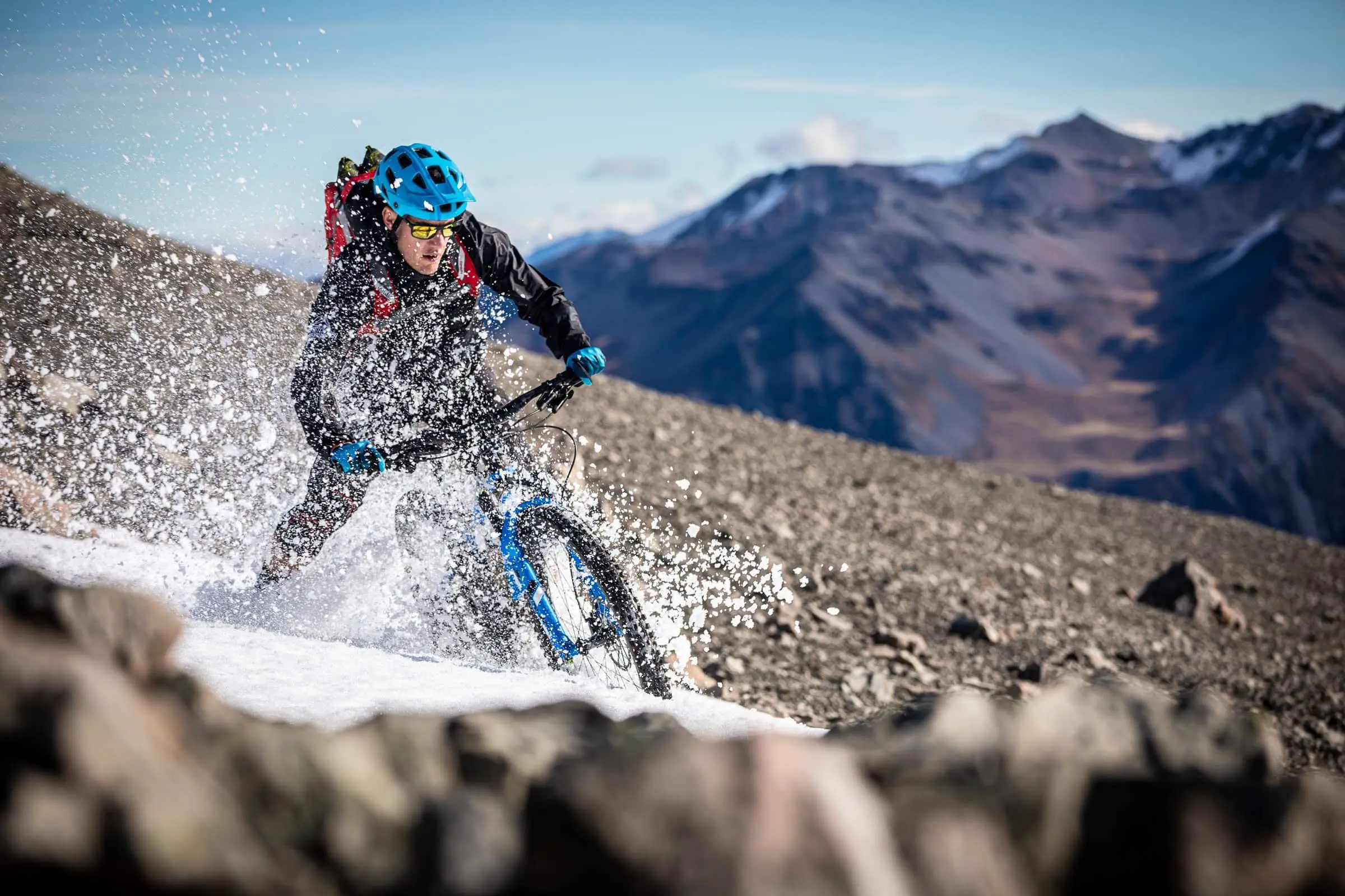 Mountain biker riding through snow in the Canterbury mountains