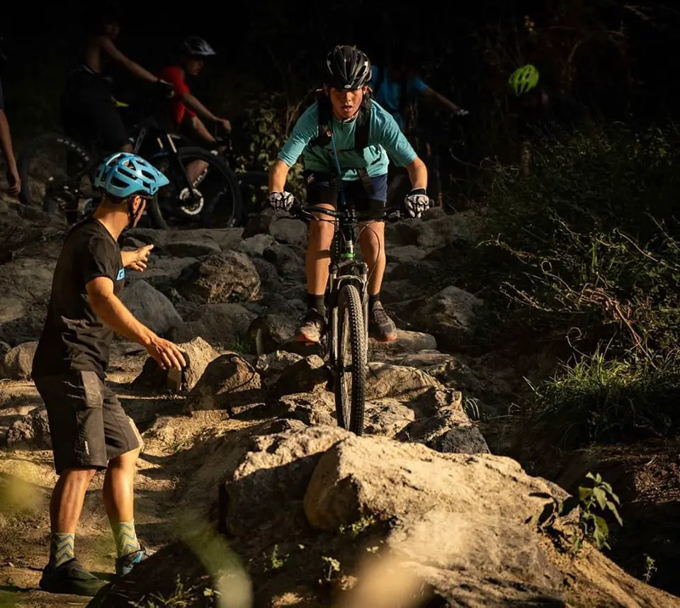 Mountain bike coaching session on rocky terrain