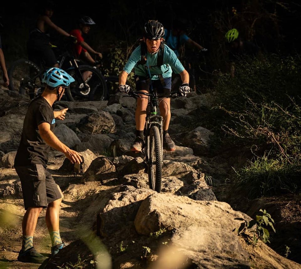 Mountain bike coaching session on rocky terrain